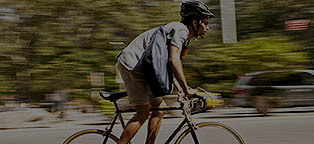 man on bike with helmet riding fast
