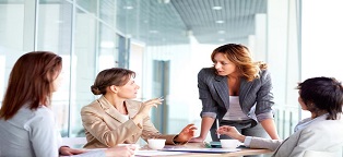 business women talking around conference table